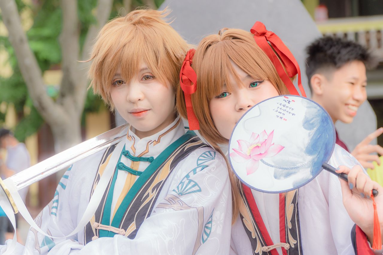 services-01 Cosplayers in traditional-inspired costumes enjoying an outdoor event with friends.