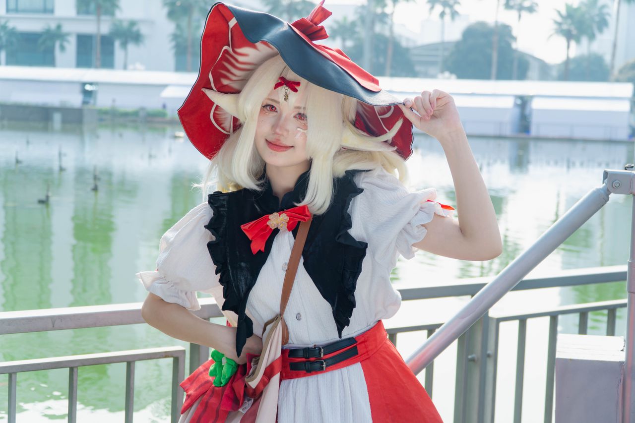 services-01 Cosplayer in bright costume by a bustling lakeside during daylight.